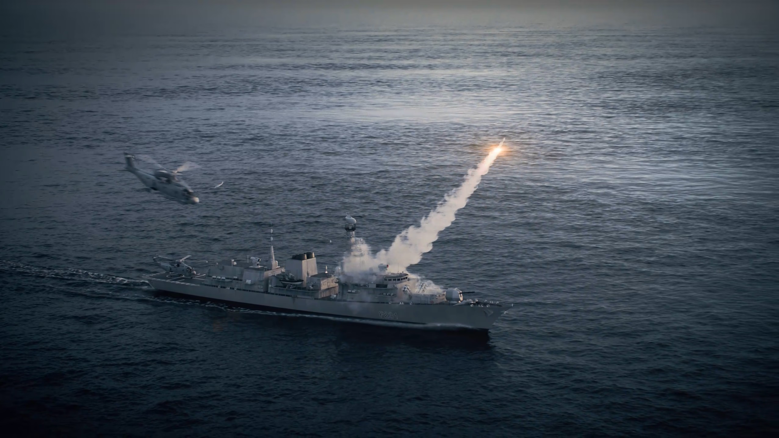 T23 naval frigate firing a missile over the ocean with Merlin helicopters flying alongside in a cinematic defence CGI visual. 